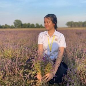 khmer student sitting in a field